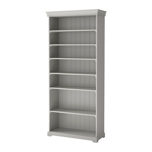 a white bookcase with four shelves on each side