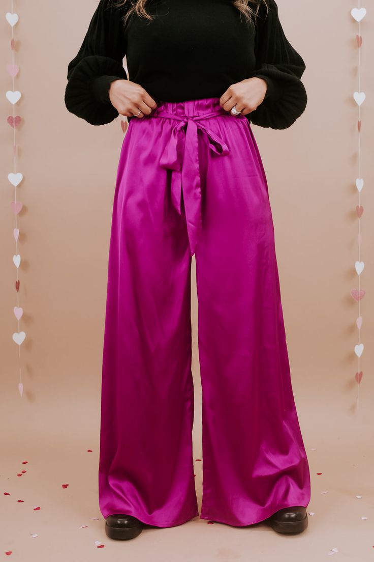 Unveil elegance with our "Best For Last" Satin Pants in Magenta. These luxurious pants exude sophistication with their smooth satin finish and vibrant magenta hue. Perfect for making a bold fashion statement at special events or elevating your everyday style. Date Night outfit inspo Waistband: High rise Fabric: 95% Polyester, 5% Spandex Sleek satin fabrication Adjustable tie belt waistband Wide leg bottom Imported Fit: True to size!- Waist: Elastic/High rise- Leg: Wide leg - Stretch only in wais Romantic Colors, Satin Pants, Everyday Chic, Leg Stretching, Chic Boutique, Bottom Clothes, Displaying Collections, Night Outfits, Date Night Outfit