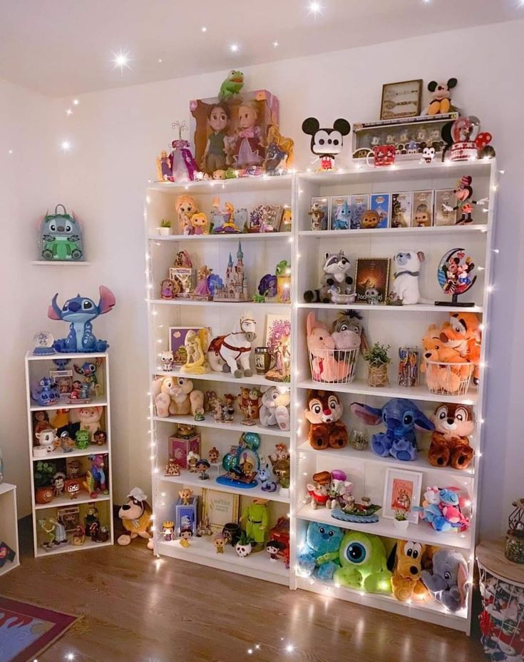 a room filled with lots of toys and stuffed animals on top of bookshelves