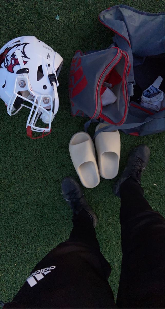 a pair of shoes and helmet laying on the grass