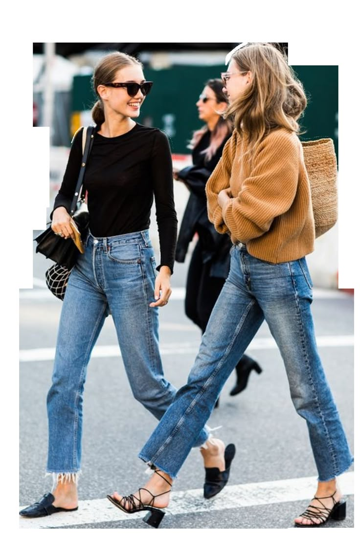 two women walking side by side in high rise jeans