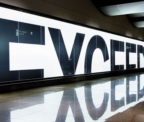 the entrance to an office building with large letters on it's wall and floor