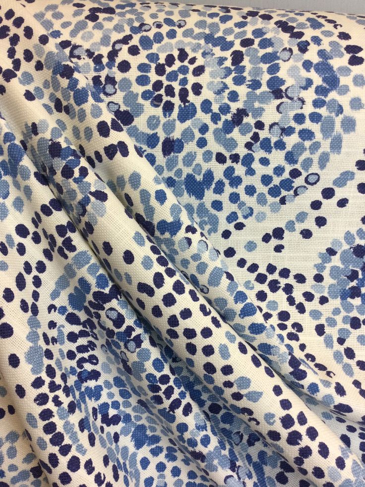 a blue and white flowered fabric with dots on the top, it is very soft