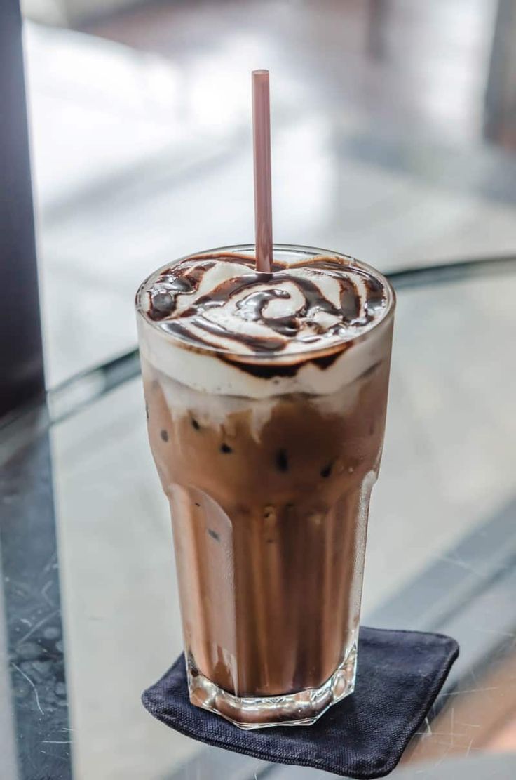 there is a chocolate drink with a straw in it