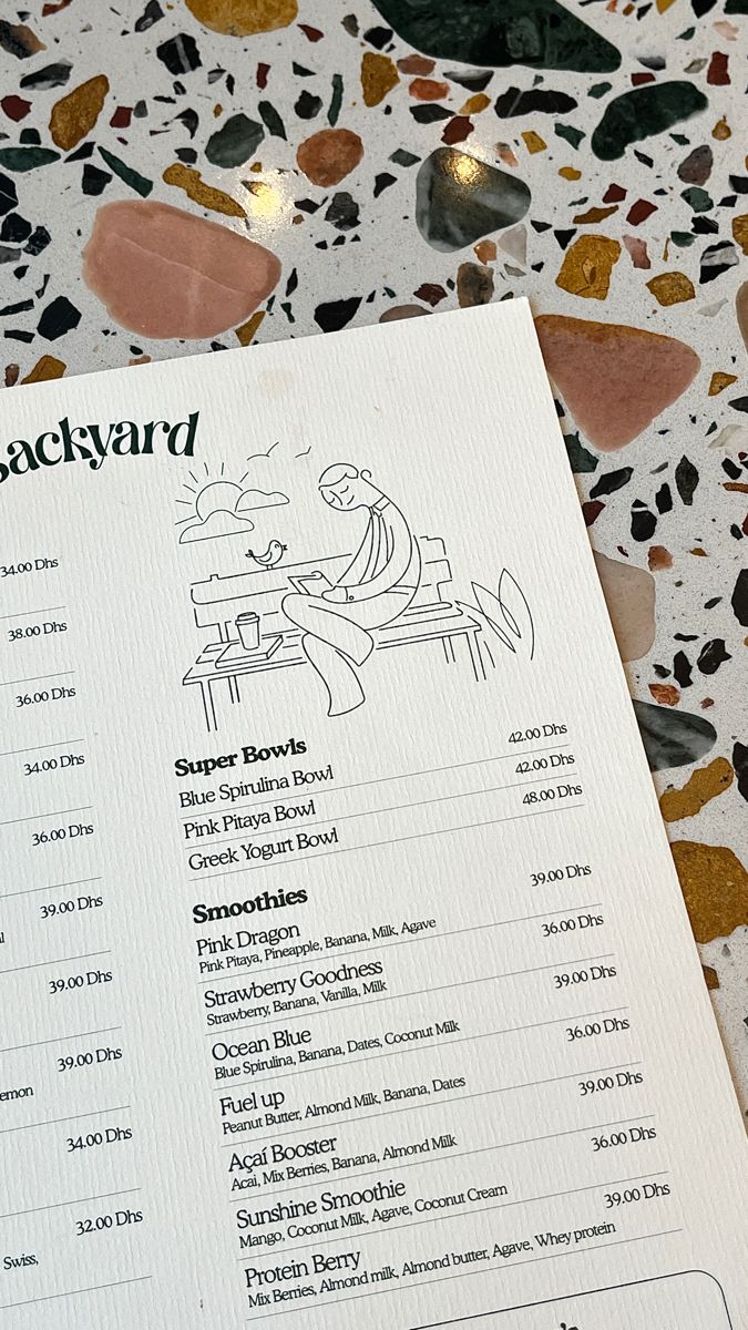 the menu for jackyard's restaurant is displayed on a table with other items