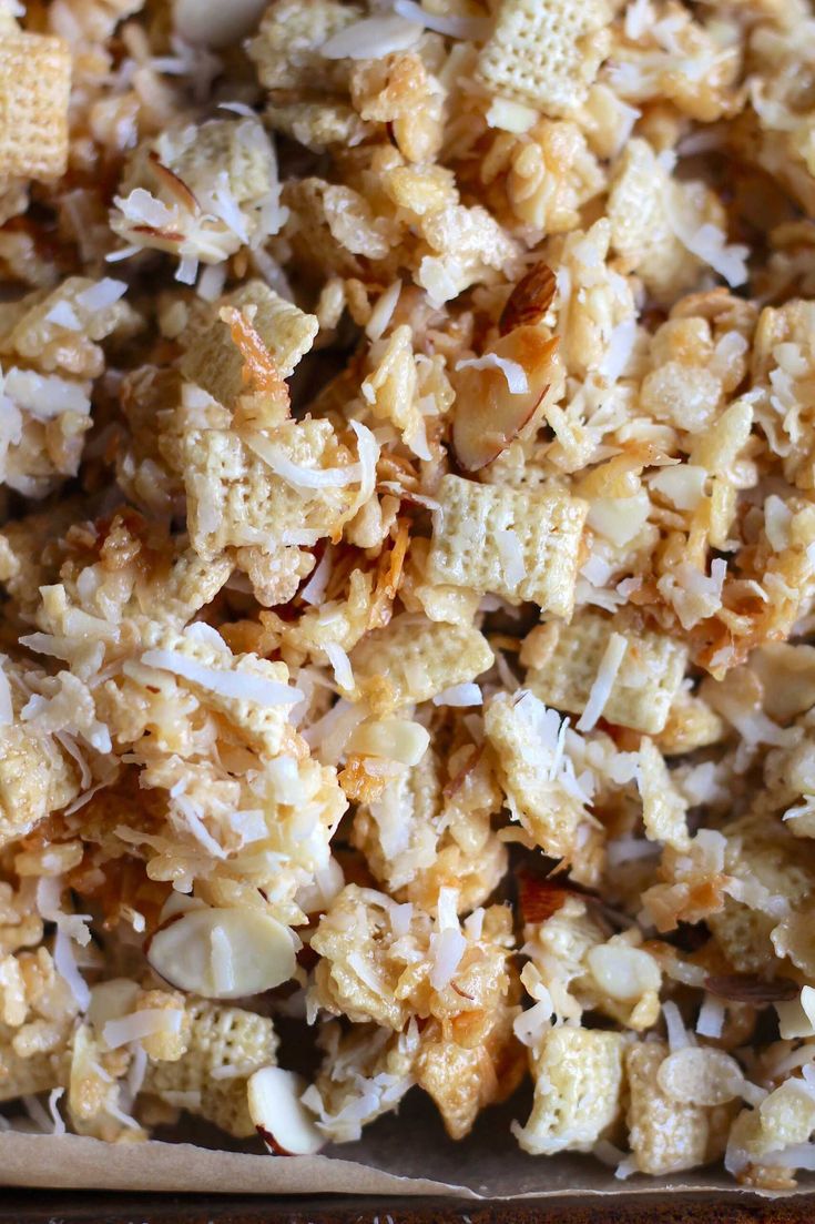 a close up view of some kind of cereal mix in a box with coconut flakes on top