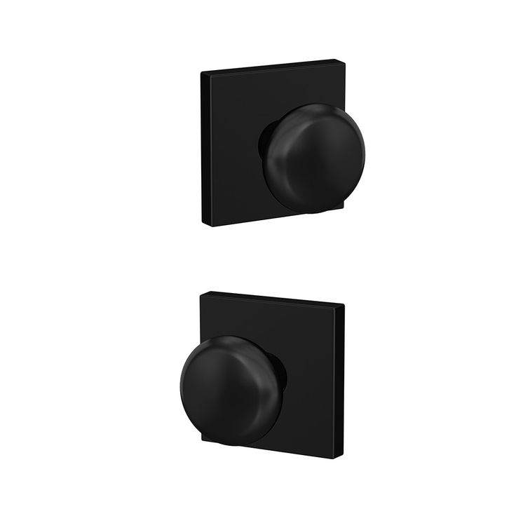 two black square knobs on a white wall and one has a round button in the middle