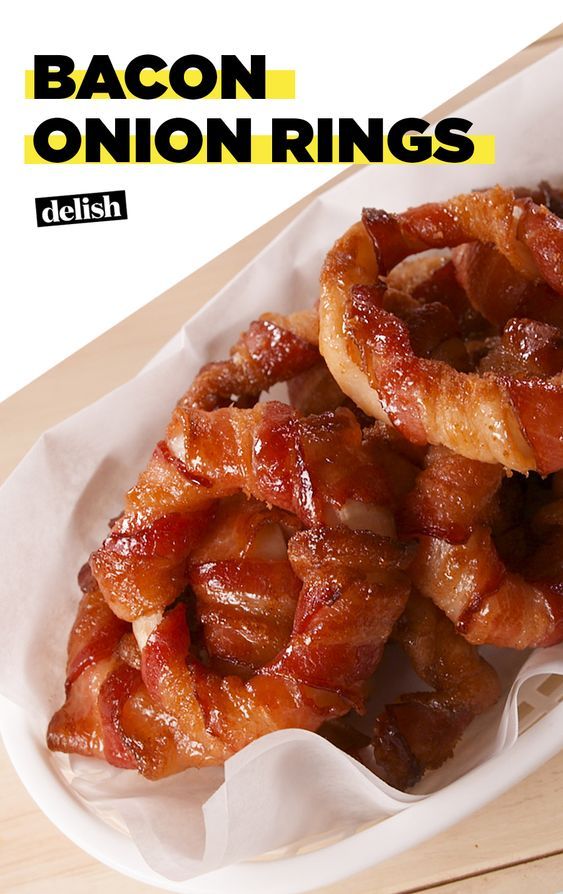 bacon onion rings in a basket on a wooden table with the words bacon onion rings above them