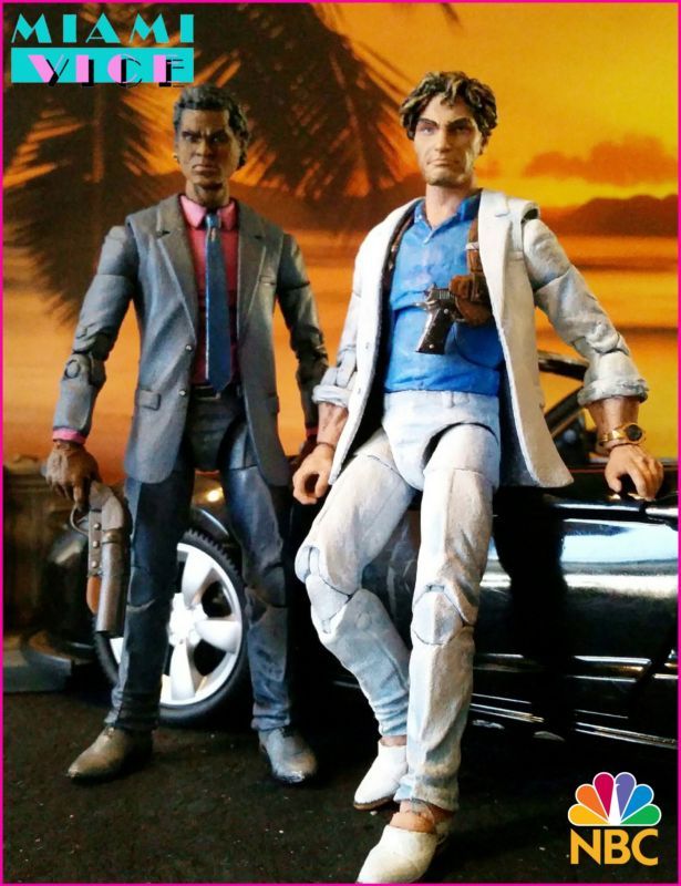 two action figures sitting on top of a car