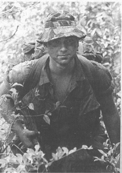 an old black and white photo of a man in the woods