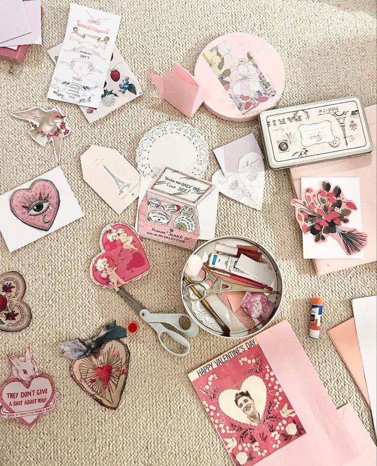 various valentine's day cards and other items laid out on the floor