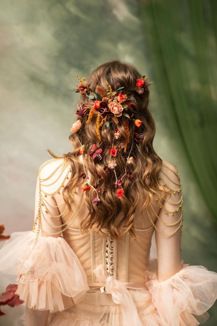 a woman with flowers in her hair is wearing a dress and looking down at the ground