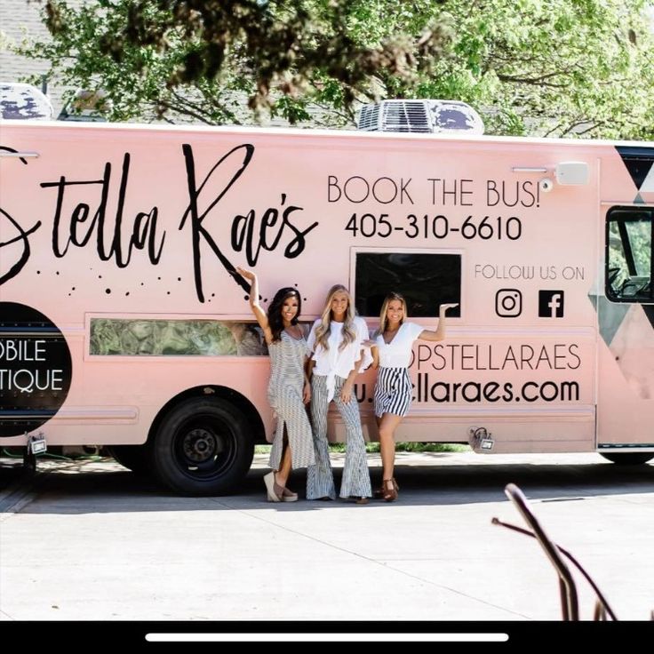 three women standing in front of a pink food truck with the words stella kaes on it