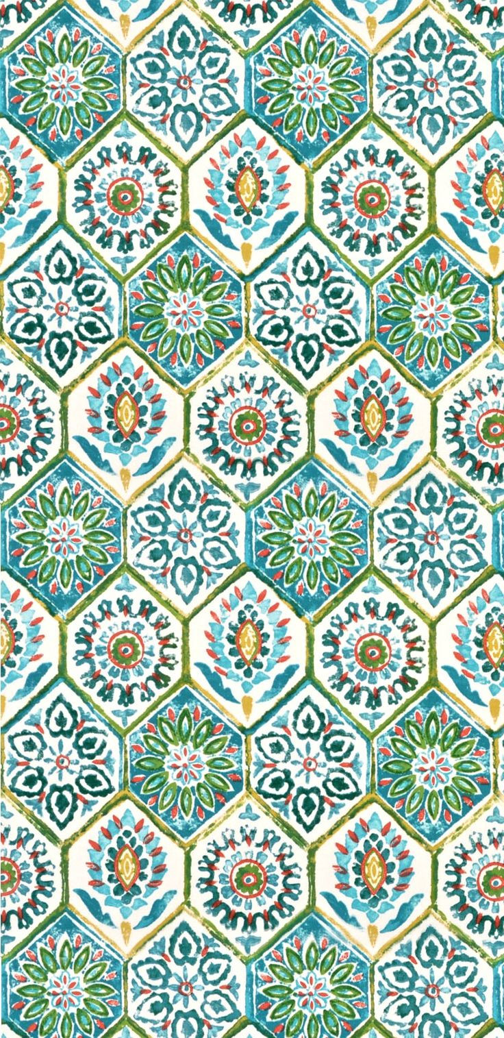 an ornate tile pattern in blue, green and orange colors on a white wallpaper background