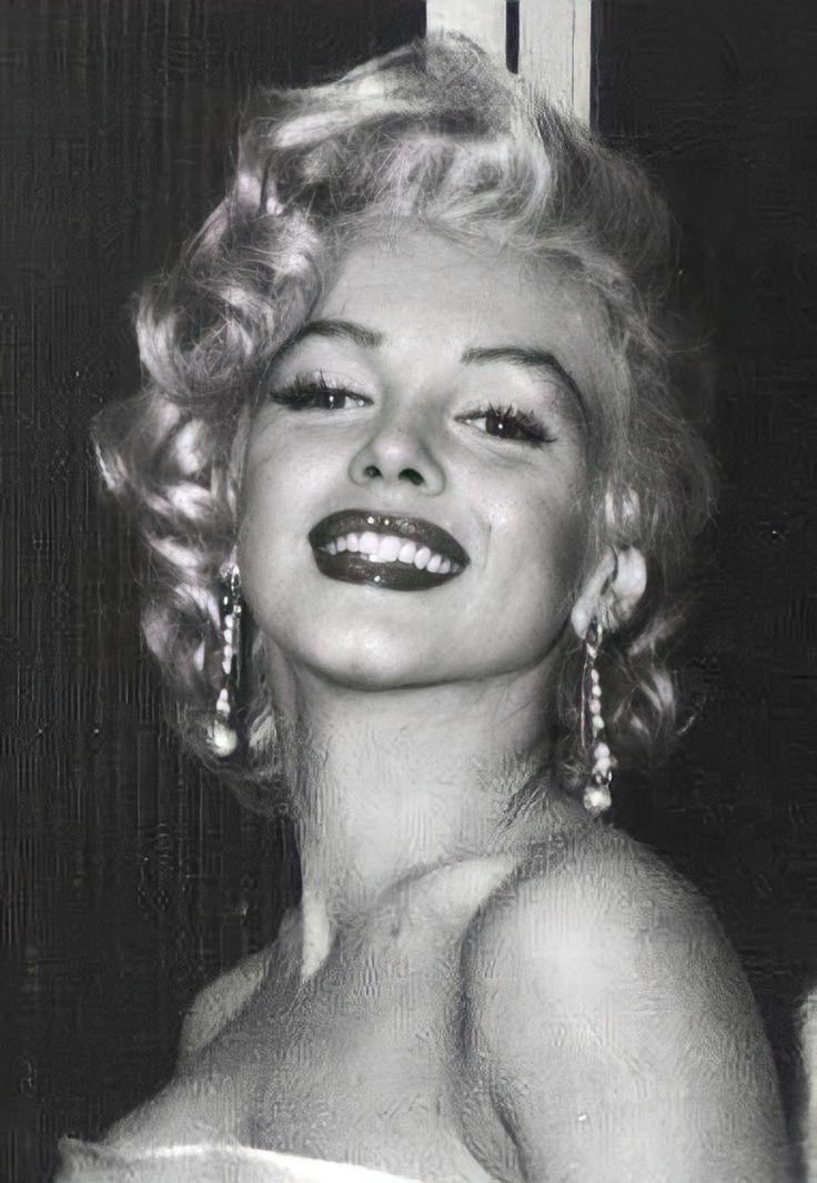 marilyn monroe is smiling and posing for the camera