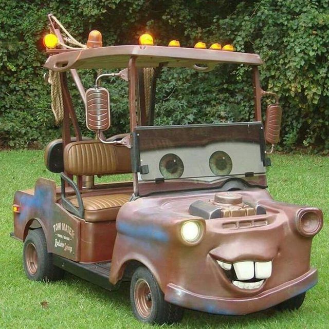 an old fashioned golf cart is painted to look like a car with eyes and mouth