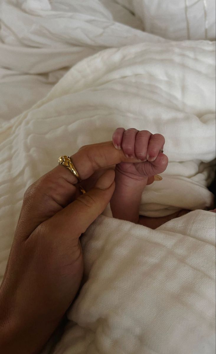 a person is laying in bed with their hand on the foot of another person's feet