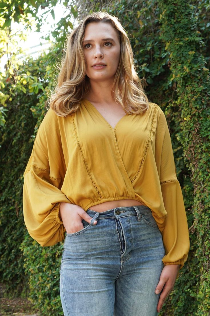 While its deep v-neck spice things up, its dolman sleeves and slightly cropped length keep it flirty and sweet. Runs true to size 95% Polyester, 5% Spandex Trendy V-neck Top With Blouson Sleeves, Flirty V-neck Spring Crop Top, Spring Flirty V-neck Crop Top, Spring V-neck Blouse For Night Out, Chic Rayon V-neck Tops, Chic Flowy Crop Top For Day Out, V-neck Rayon Tops For Day Out, Bohemian V-neck Top For Night Out, Rayon V-neck Tops For Day Out