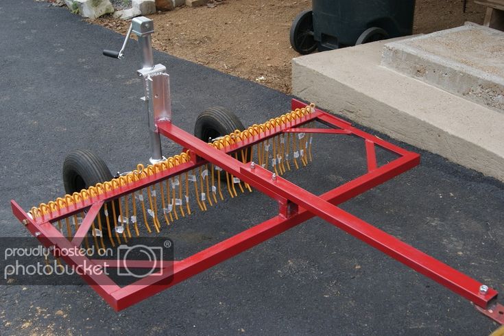 a red cart with wheels on the ground