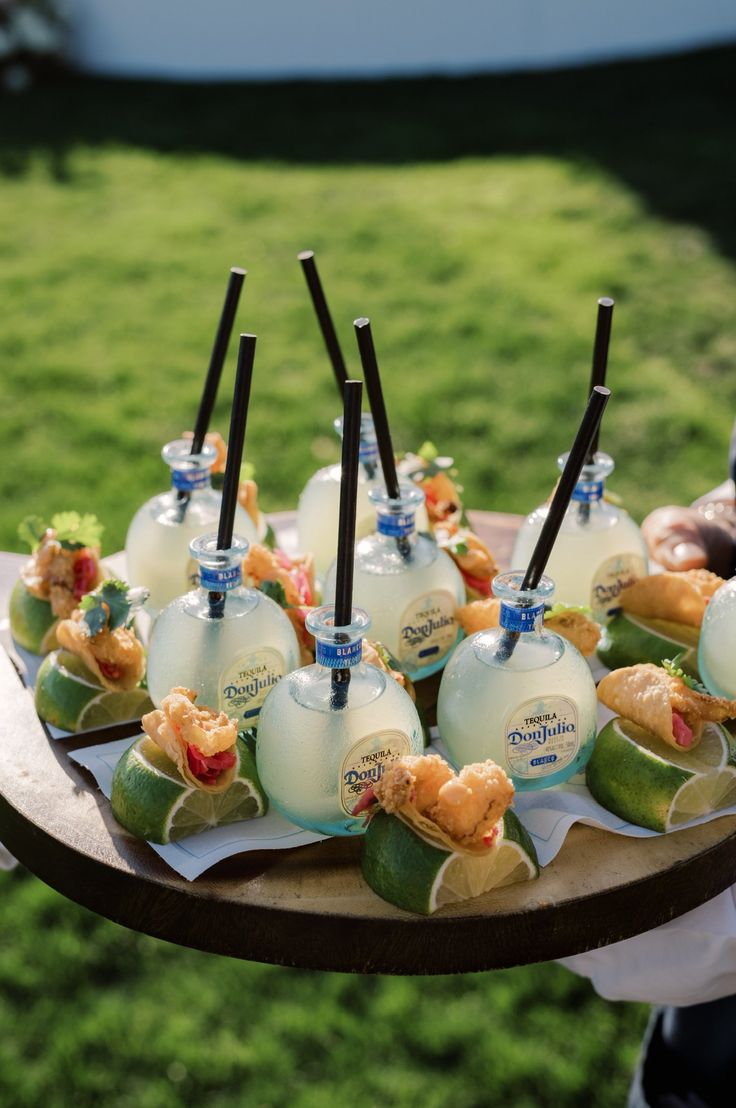 there is a tray with many bottles on it that are filled with different types of drinks