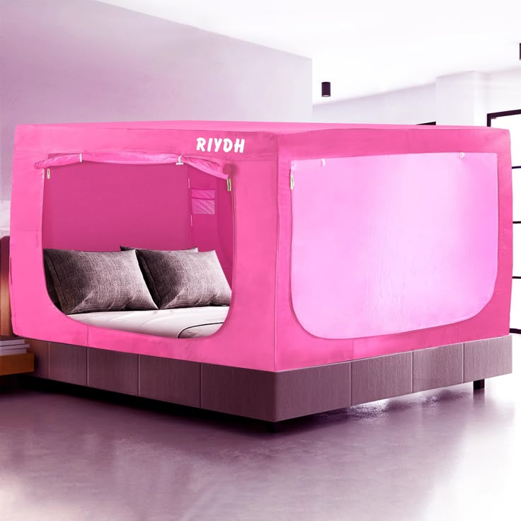 a bed that is made to look like a tv set with pink walls and windows