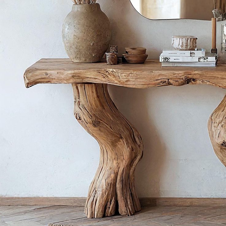 a wooden table with a mirror and vase on it