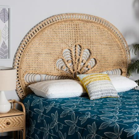 a wicker headboard on a bed in a bedroom with blue bedspread