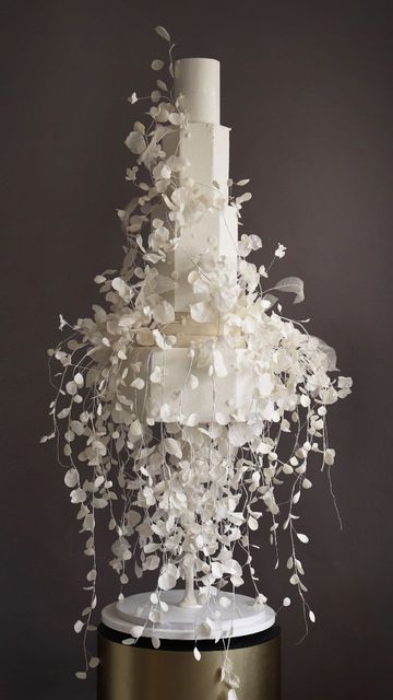 a wedding cake with white flowers on top