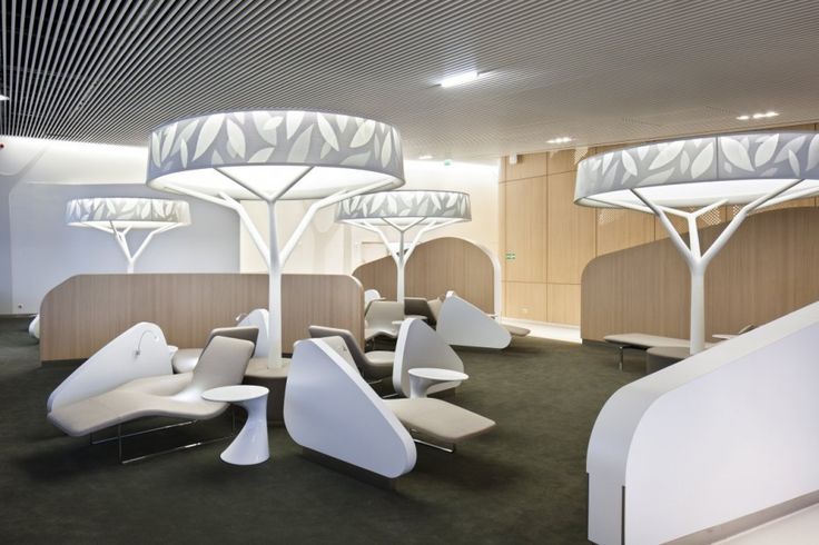 the interior of an office building with modern furniture