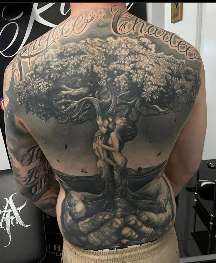 the back of a man's body with an image of a tree on it