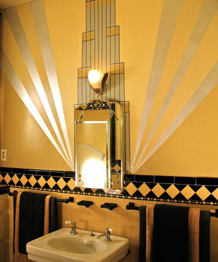 a bathroom with a sink, mirror and towels on the rack in front of it