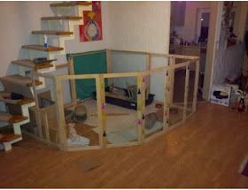 a living room filled with furniture and lots of wood flooring next to a stair case