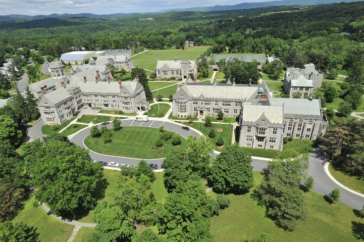 an aerial view of a large building surrounded by trees