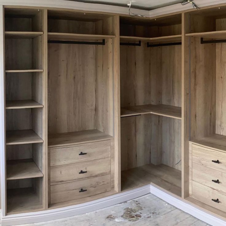 an empty walk in closet with shelves and drawers