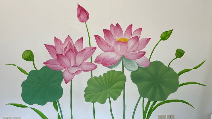 a painting of pink flowers and green leaves on a white wall next to two candles