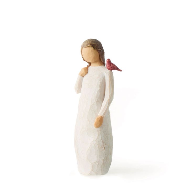 a ceramic figurine of a woman holding a bird on her shoulder, against a white background