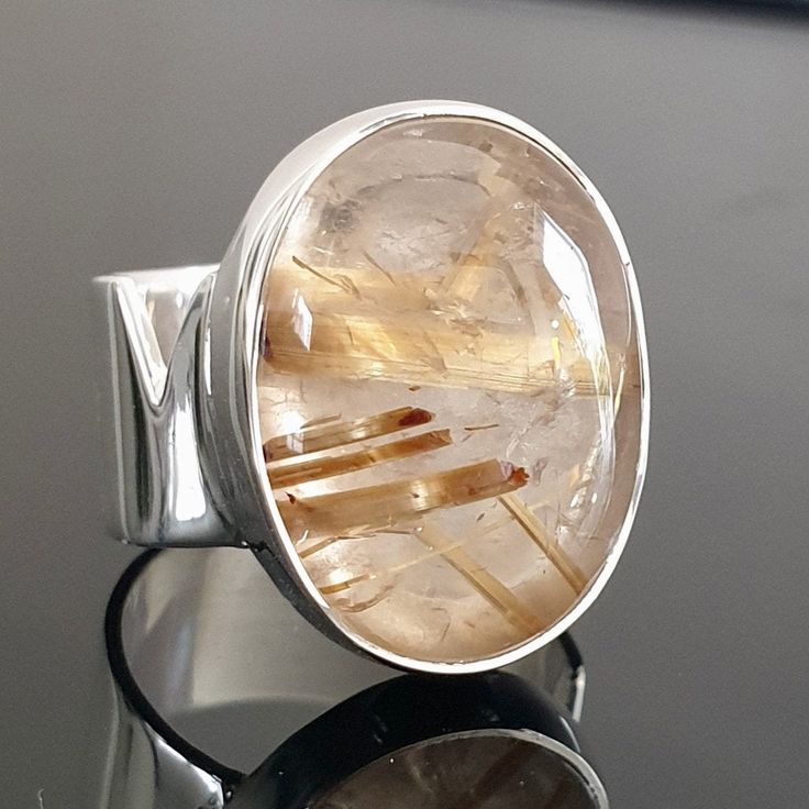 Excited to share the latest addition to my #etsy shop: Large Natural Golden Rutile Quartz Ring, Wide 925 Sterling Silver Rings Women, Statement Ring, Gold Stone, Engagement Ring, Mistry Gems,R200 https://etsy.me/3bWQREy Statement Engagement Ring, Rings Women, Golden Rutilated Quartz, Hair Jewellery, Angel Hair, Rutile Quartz, Plastic Ring, Jewellery Gold, Gold Stone