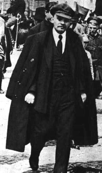 an old photo of a man in a suit and tie walking down the street with other people