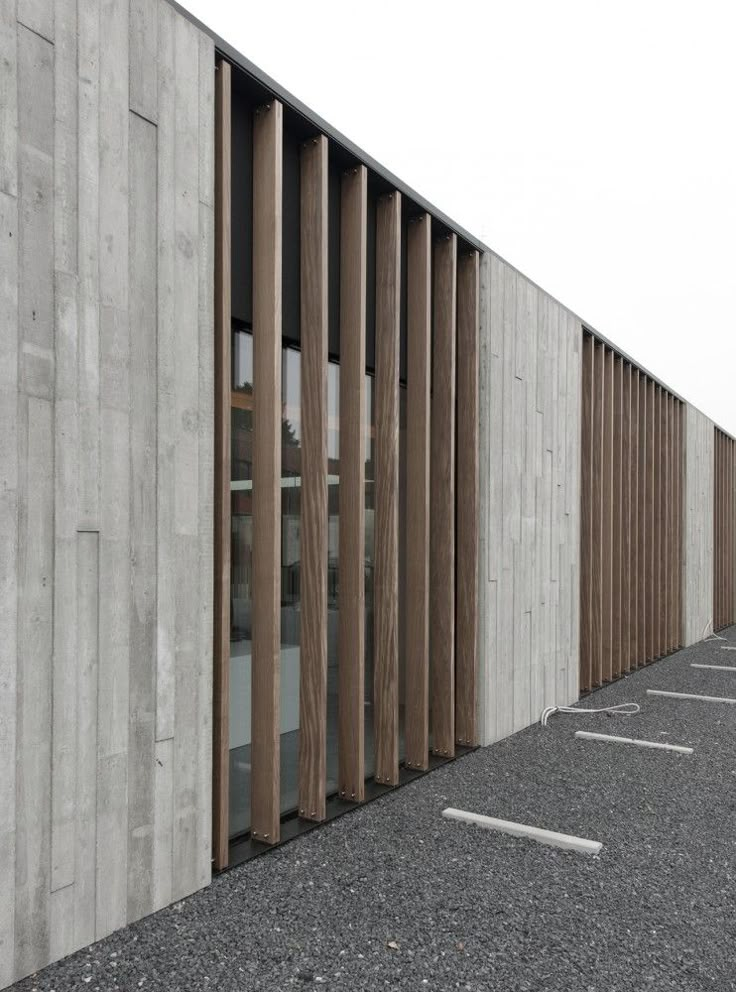 an empty parking lot next to a concrete building