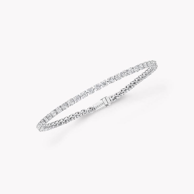 The ultimate expression of timeless design, our round diamond bracelet in white gold from the Classic Graff collection is simply stunning. The diamonds are embraced in minimal metal settings, creating a delicately scintillating statement on the wrist. The Classic Graff collection is the epitome of elegance – a unique selection of jewels designed to showcase the remarkable purity and brilliance of the finest Graff diamonds. An elegant Classic Graff round diamond bracelet with a total weight of ap Dubai Fits, Round Diamond Bracelet, Graff Jewelry, Graff Diamonds, Diamond Drop Necklace, Diamond Earrings Studs Round, Bracelet Tennis, Diamond Bangles Bracelet, Platinum Jewelry