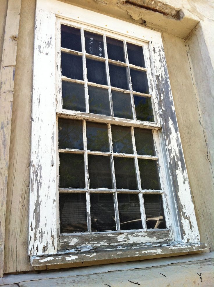 an old window on the side of a building