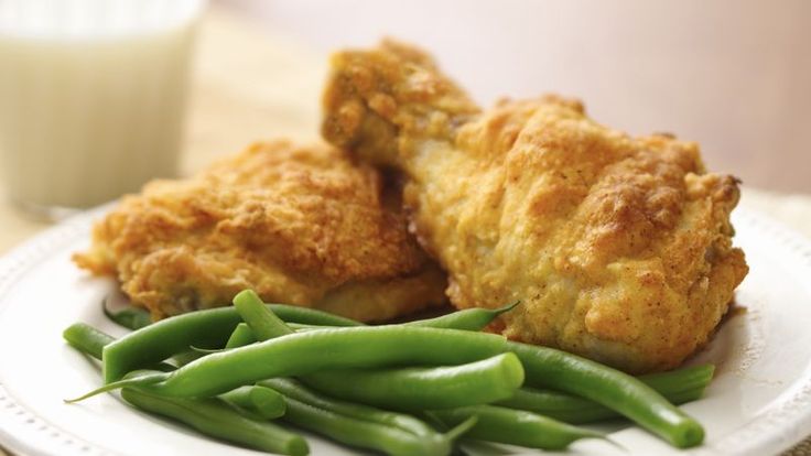 fried chicken and green beans on a plate with a glass of milk