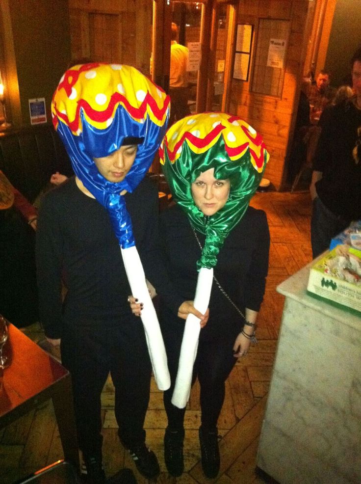 two people in costumes holding large balloons