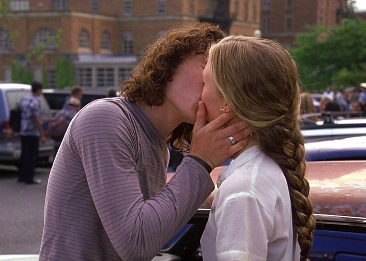 two women kissing each other on the street