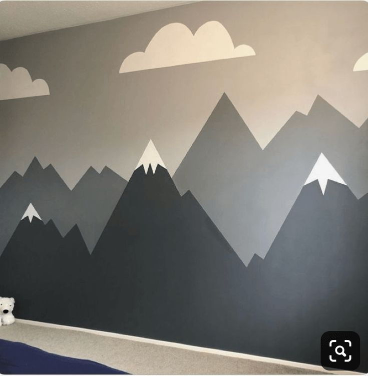 a bedroom with mountains painted on the wall