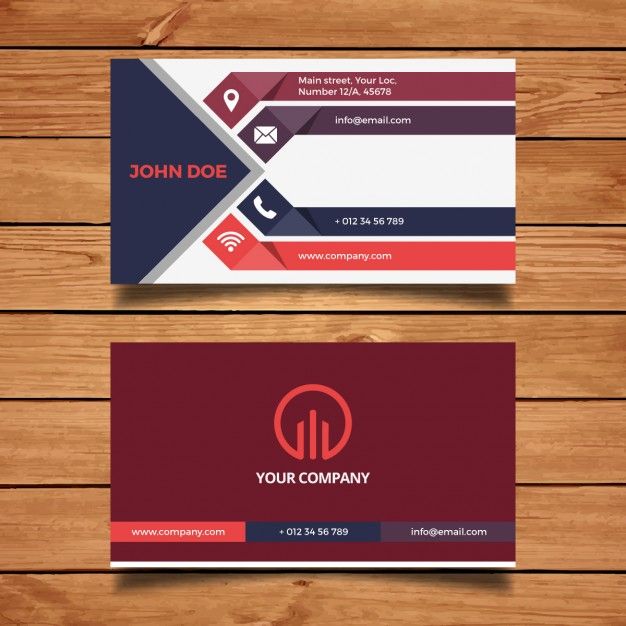 two business cards with different colors and shapes on wood planks, one has a phone logo