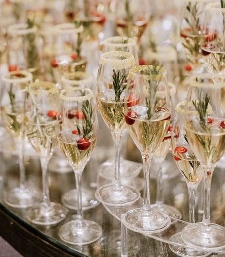 many wine glasses are lined up on a table