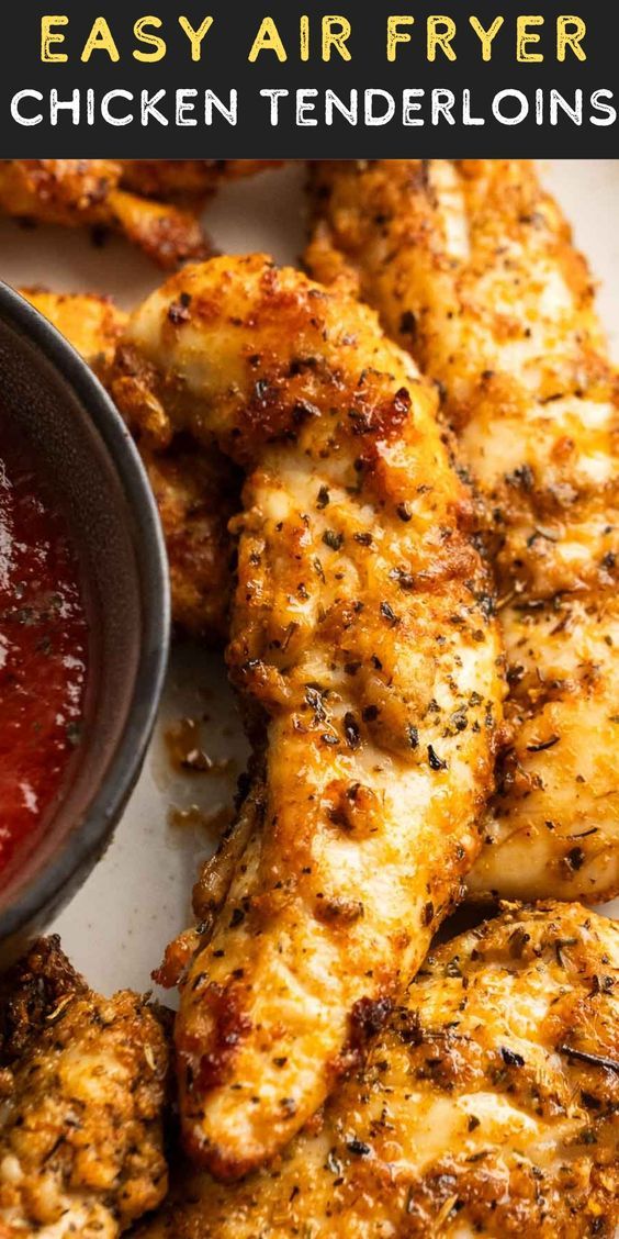 grilled chicken tenders with ketchup on the side and text overlay that reads easy air fryer chicken tenderies