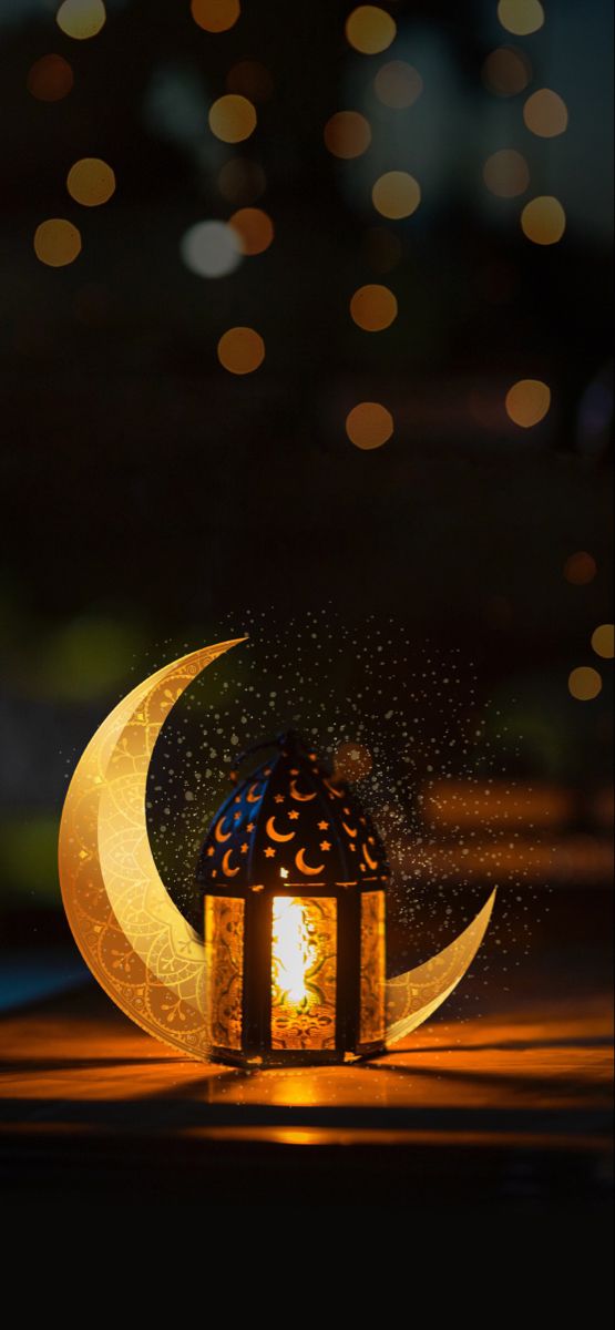 an illuminated lantern with the moon and stars in the background