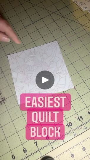 someone is cutting paper with scissors on the floor next to a piece of paper that says, easiest quilt block